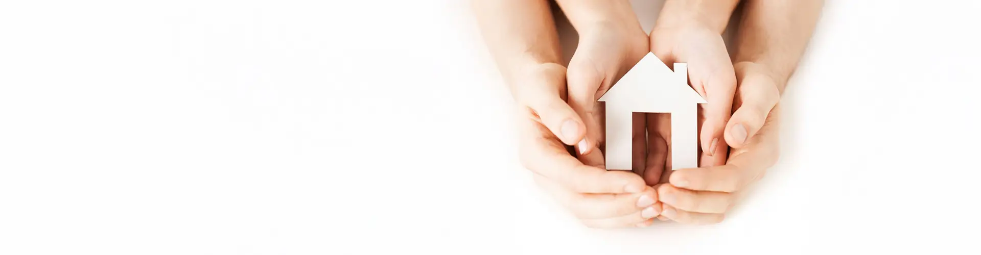 Man and woman hands holding a house
