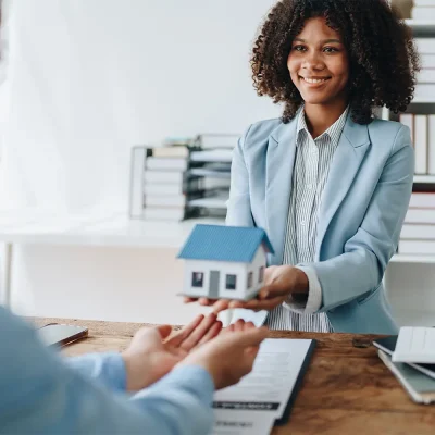 Female housing counselor helps person prepare for their housing goals. Female housing counselor helps person prepare for their housing goals.